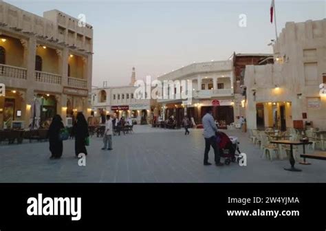 Souq Waqif In Doha Qatar Main Street At Sunset Showing Qatar Flag Over