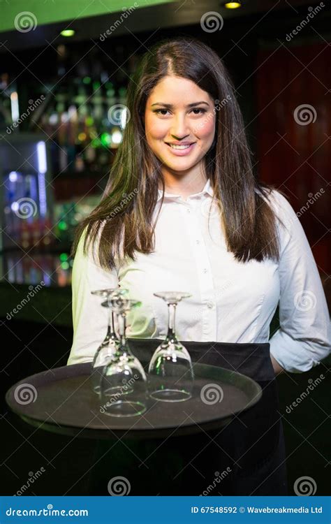 Portrait Of Pretty Waitress Holding A Tray With Wine Glasses Stock