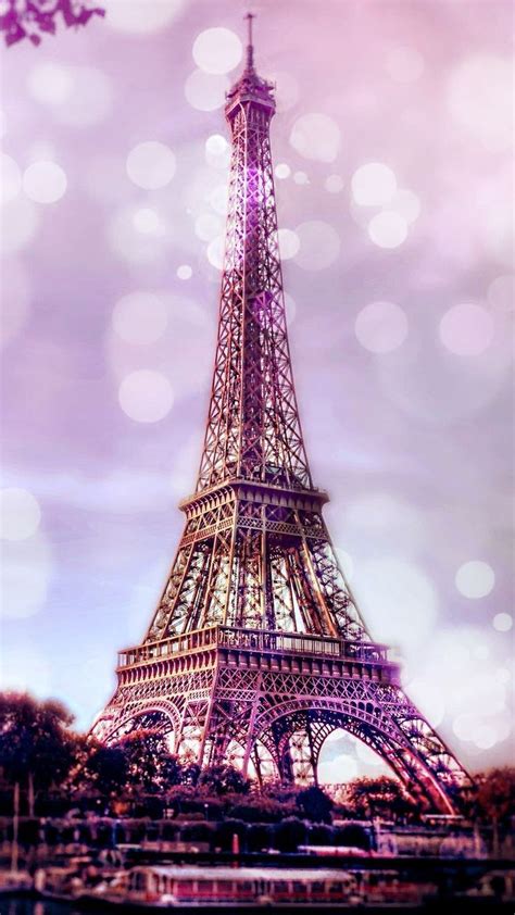 the eiffel tower is lit up with purple lights