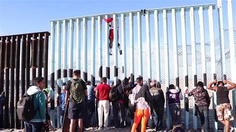 Immigrants Climb Over Us Mexico Border Wall Youtube