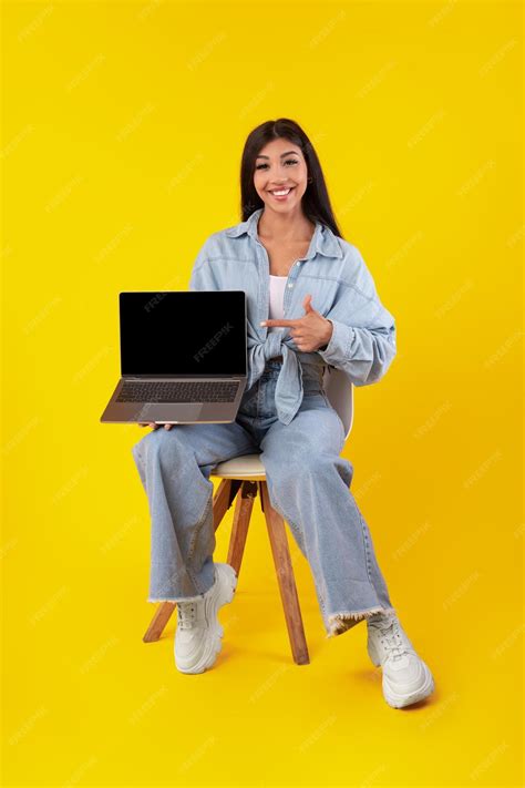 Premium Photo | Happy woman pointing at black empty laptop screen