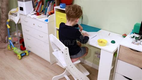 Child Engages in Creative Drawing Activity at Home in a Bright and ...