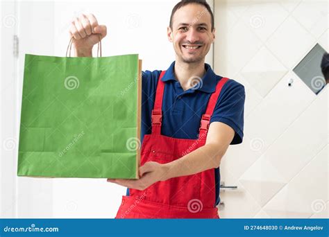 Two Boxes With Fast Food Being Carried By Delivery Man In Uniform For