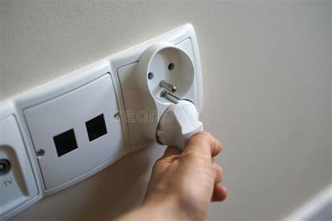 woman hand plug unplug put pulls cable cord  socket outlet charge