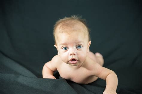 Premium Photo Blue Eyed Naked Baby Lying On Black Fabric