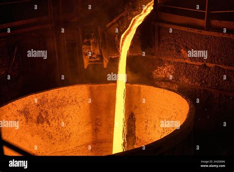 A Stream Of Molten Slag Is Poured Into A Metallurgical Ladle Stock