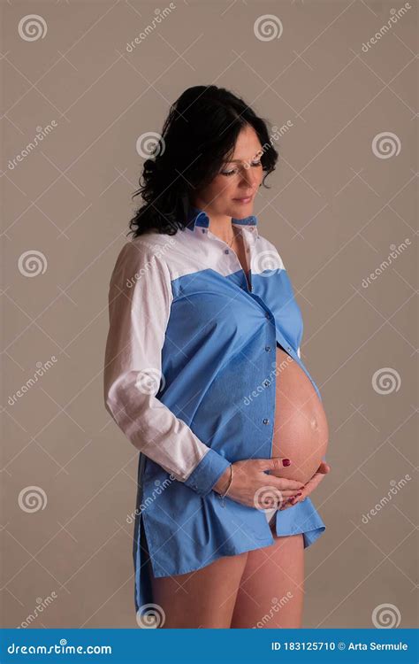 Portrait Shoot Of Young Beautiful Pregnant Woman Posing For Maternity