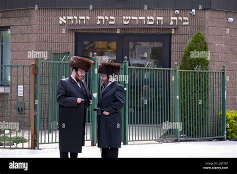 During Passover Hasidic Jewish Men Wearing Shtreimel Fur Hats Have A Conversation Outside Of A