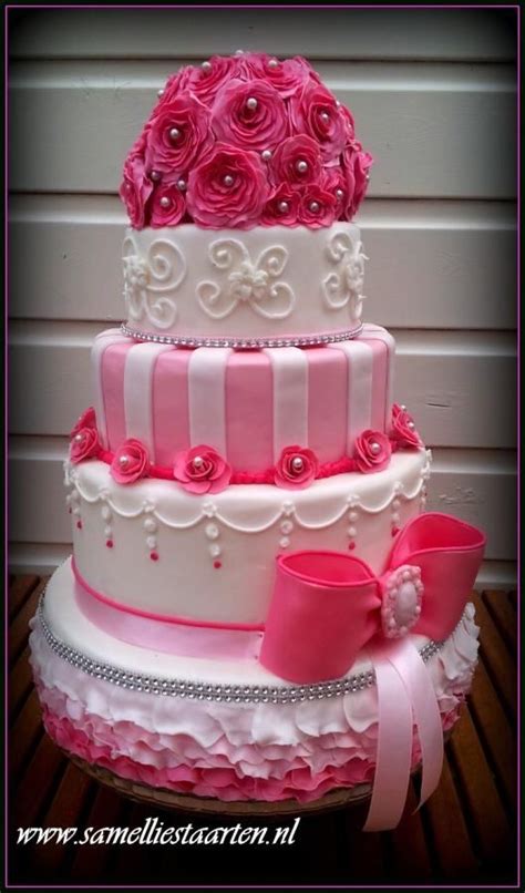 A Three Tiered Cake With Pink Roses On Top