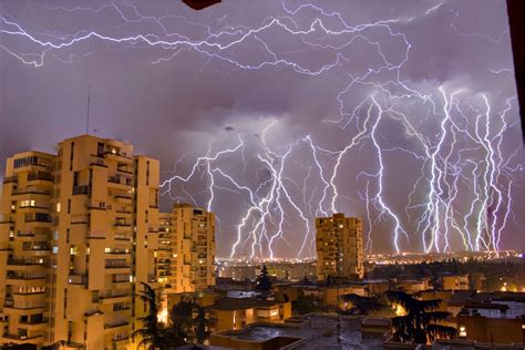 Brown Concrete Buildings Under Lightning · Free Stock Photo