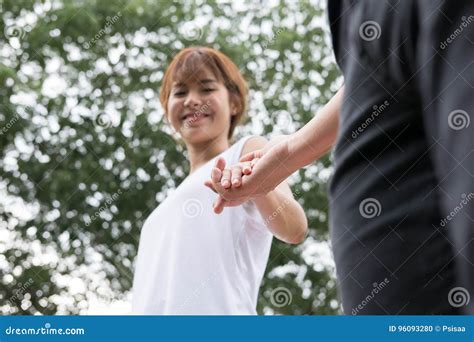 Happy Young Couple Holding Hands In Garden Boyfriend And Girlfriend