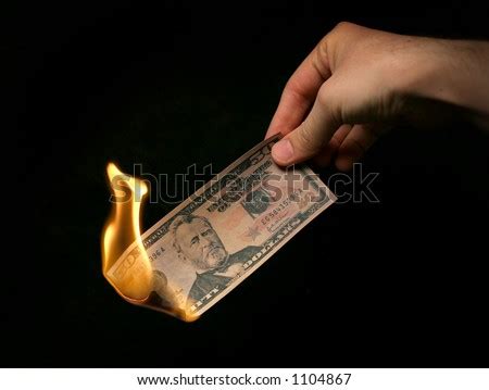 Money To Burn A Hand Holding A Fifty Dollar Bill On Fire Stock Photo