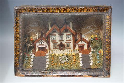 A Victorian Diorama Depicting A House With Flower Garden In The