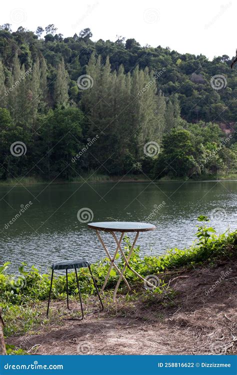 Camping Site By The Lake Surrounded With Green Pine Trees Stock Photo