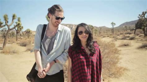 A Man And Woman Walking In The Desert