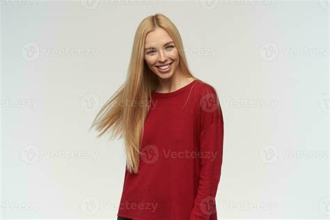 Portrait Of Attractive Adult Girl With Blond Long Hair Wearing Red Sweater People And Emotion