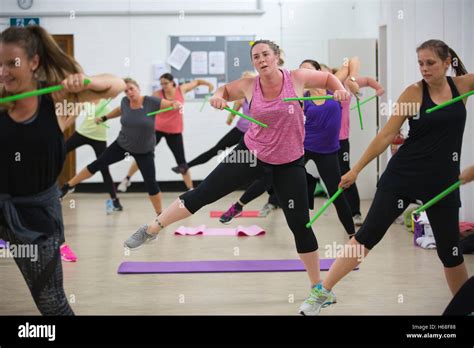 Women participating in POUND fitness class, hour long workout drumming ...