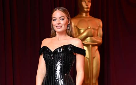 Margot Robbie Holds Court at Oscars 2023 in Black Armani Dress & Pumps ...