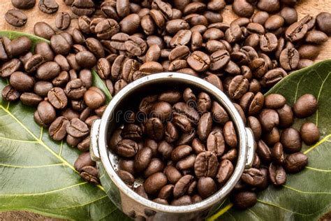 Roasted Columbian Coffee Beans Placed On A Wooden Table Stock Photo