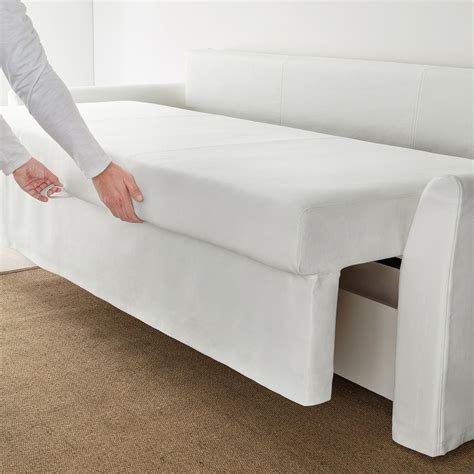 A Person Is Pulling The Mattress Off Of A Couch