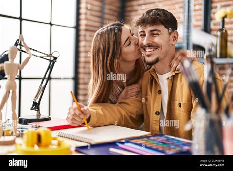 Mand And Woman Artist Couple Drawing On Notebook Kissing At Art Studio