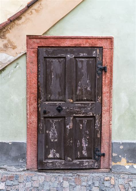 Small Weathered Wooden Door In A Facade Of Old House Stock Photo