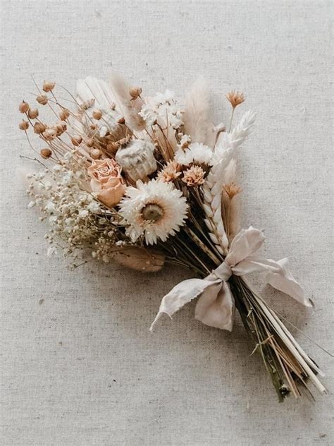 A Bunch Of Dried Flowers Sitting On Top Of A Table