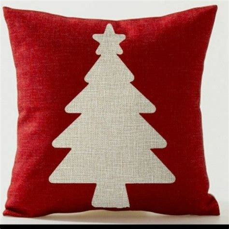 A Red Pillow With A White Christmas Tree On It