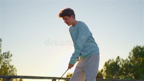 Golf Game A Golfer Hits The Ball In The Sunlight People Sport