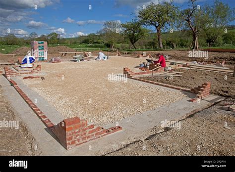 Bricklayer Laying Brick Corners On Strip Footings For New Foundations