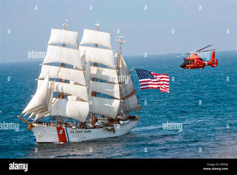 The Coast Guard Cutter Eagle Sails In The Atlantic Ocean Followed By A