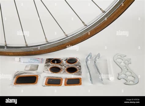 A bicycle repair kit next to a wheel Stock Photo - Alamy