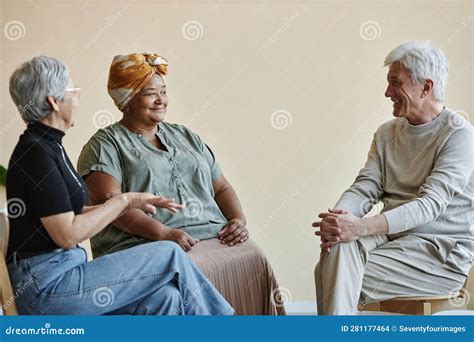 Senior People Sitting In Circle At Mental Health Support Group And