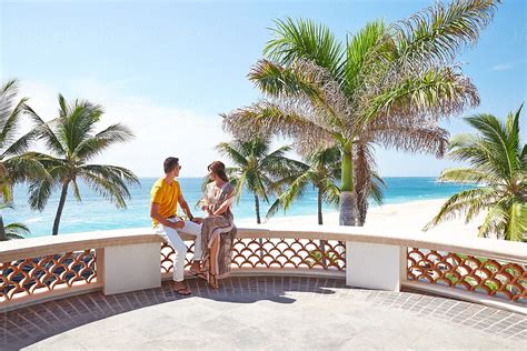 Couple On Deck At Luxury Beach Resort In Mexico By Stocksy