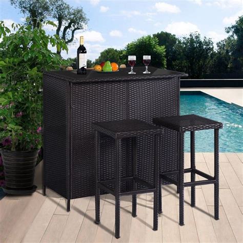 an outdoor bar with three stools next to a pool