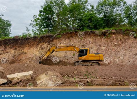 Backhoe Working By Digging Soil At Construction Site And Loading To The