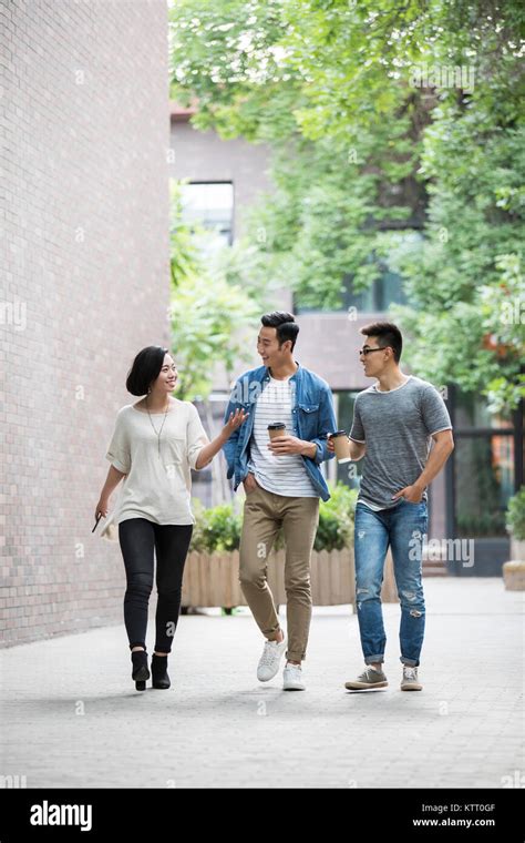 Cheerful young friends talking outdoors Stock Photo - Alamy