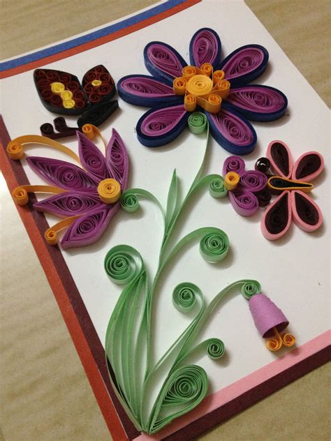 A Card With Paper Flowers And Butterflies On It