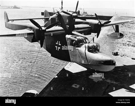 A Blohm And Voss Bv 138 Flying Boat Is Lowered Into A Harbor Basin Stock