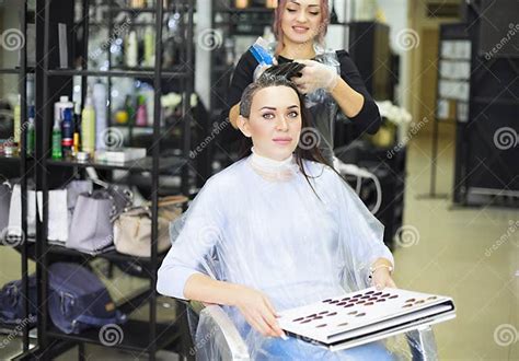 Gorgeous Happy Woman Looking To The Camera While Examining Hair Dye