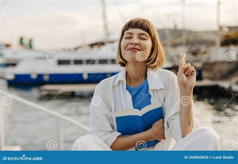 Satisfied Young Caucasian Girl Closing Her Eyes Makes Wish With Fingers