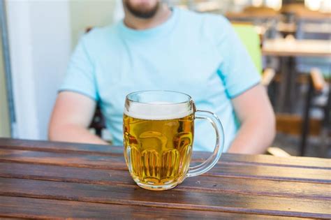 Premium Photo Midsection Of Man Drinking Glass On Table