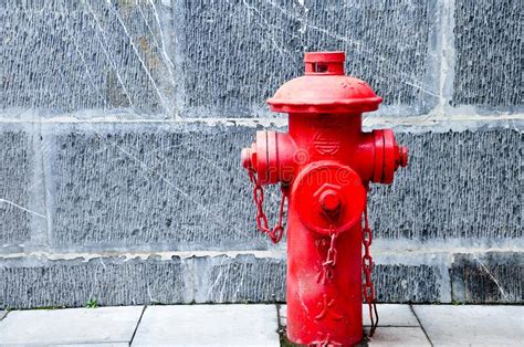 Red Fire Hydrant With An Opened Seal And A Long White Fire Hose Without