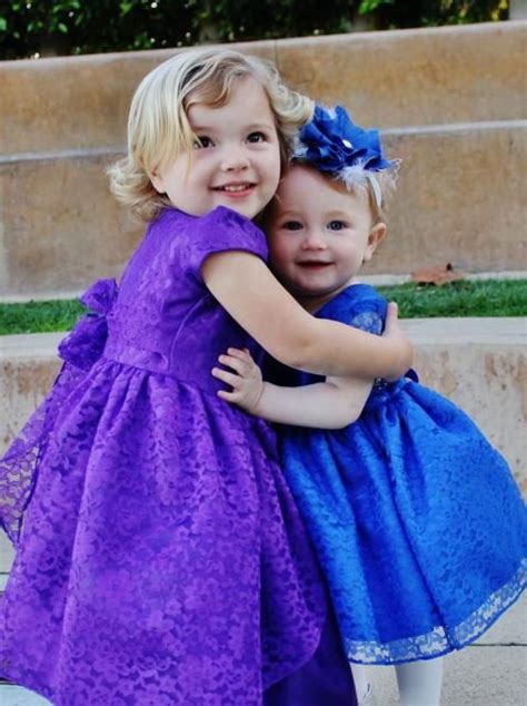 Cute Adorable Girl Baby Is Looking Up Wearing Purple Dress