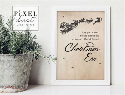 A Framed Christmas Card Next To A Potted Plant On A White Shelf With