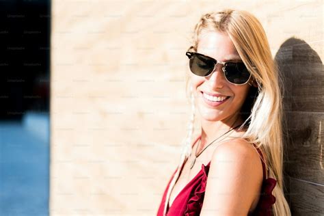 Happy Beautiful Blonde Woman Wearing Sunglasses Smiling In A Wood Wall Photo Summer Image On