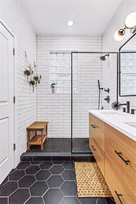 A Bathroom With Black And White Tile Flooring Wooden Cabinets And A