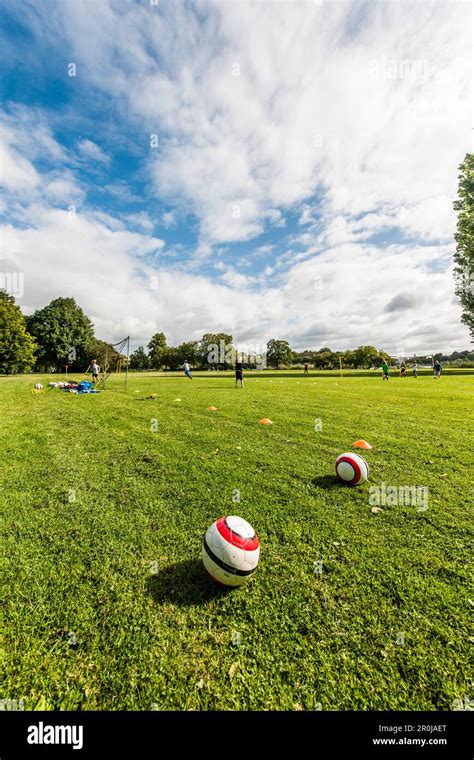 Two Balls In Grass Soccer Players In Background Hamburg Germany