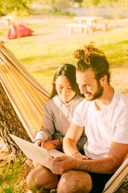 Free Photo Trendy Couple Relaxing Together In Hammock Outdoors