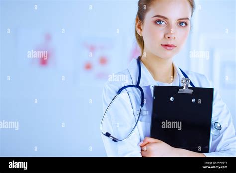 Female Doctor In The Office With A Folder In Her Hands Medical